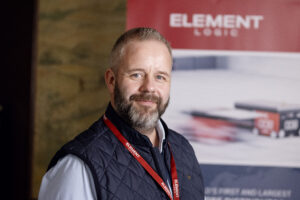 Picture of Erik Irwing at Speed with Element Logic logo in the background