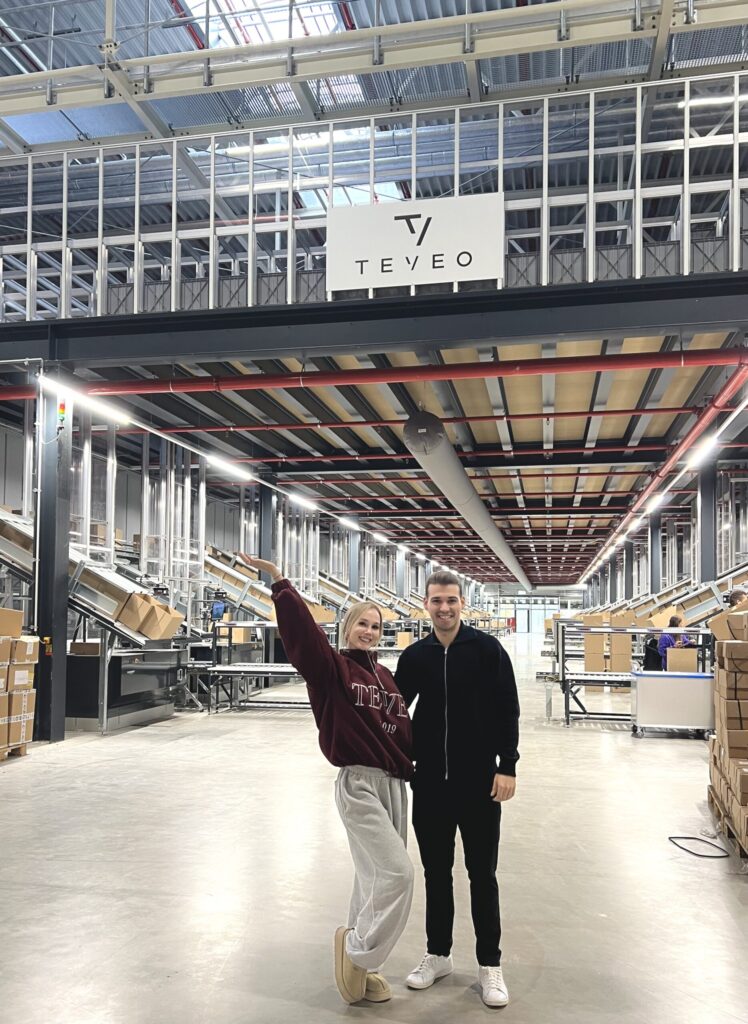 A picture of Teveo founders posing in front of the warehouse built by Element Logic.