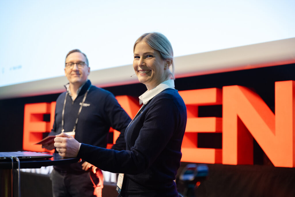A picture of Emmelie from Element Logic on stage smiling to the camera