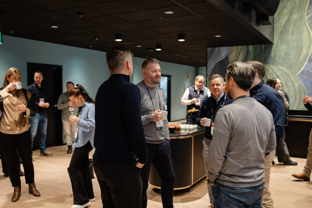 A picture of people drinking coffee and mingle during break