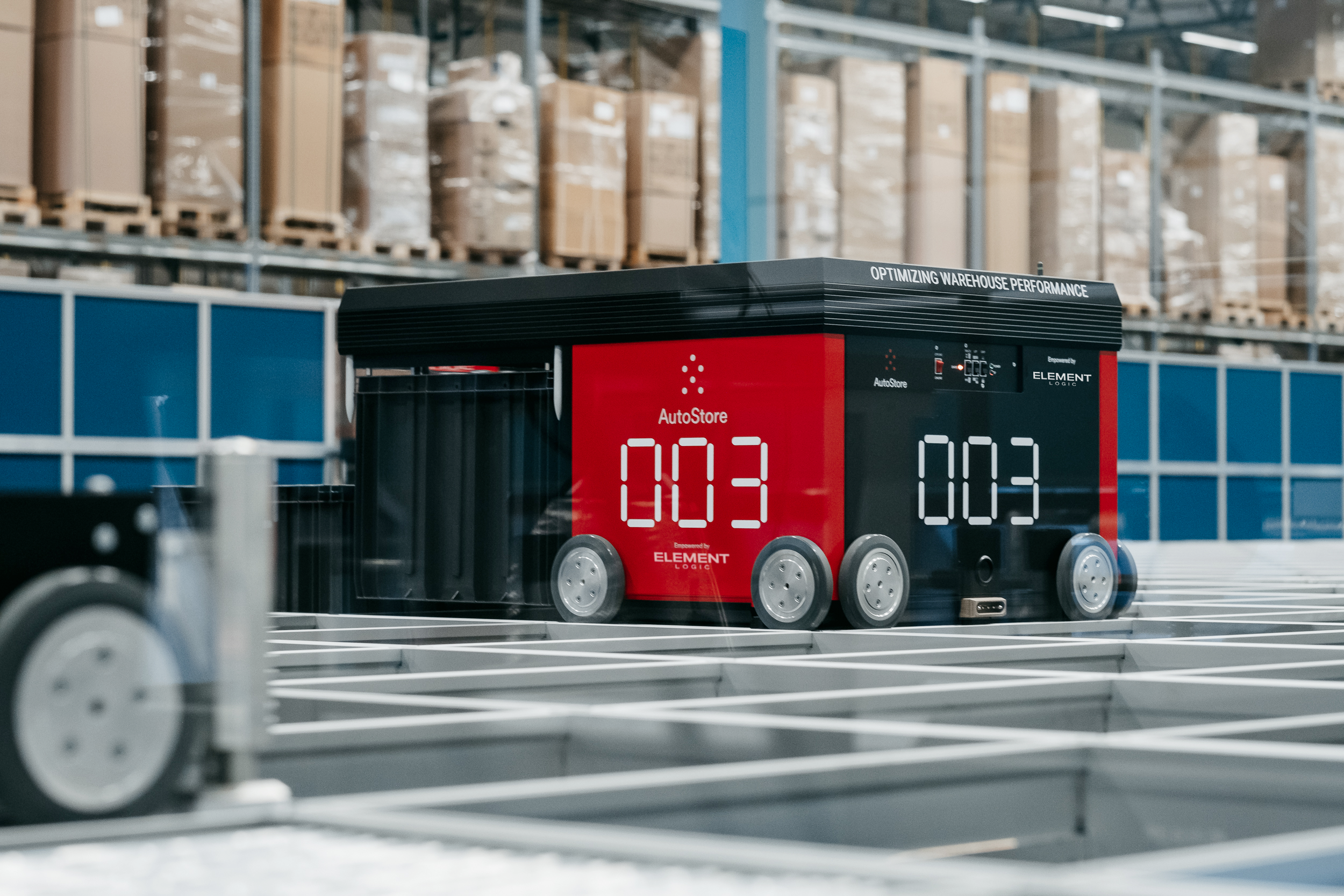 AutoStore robot on top of a grid with a bin.