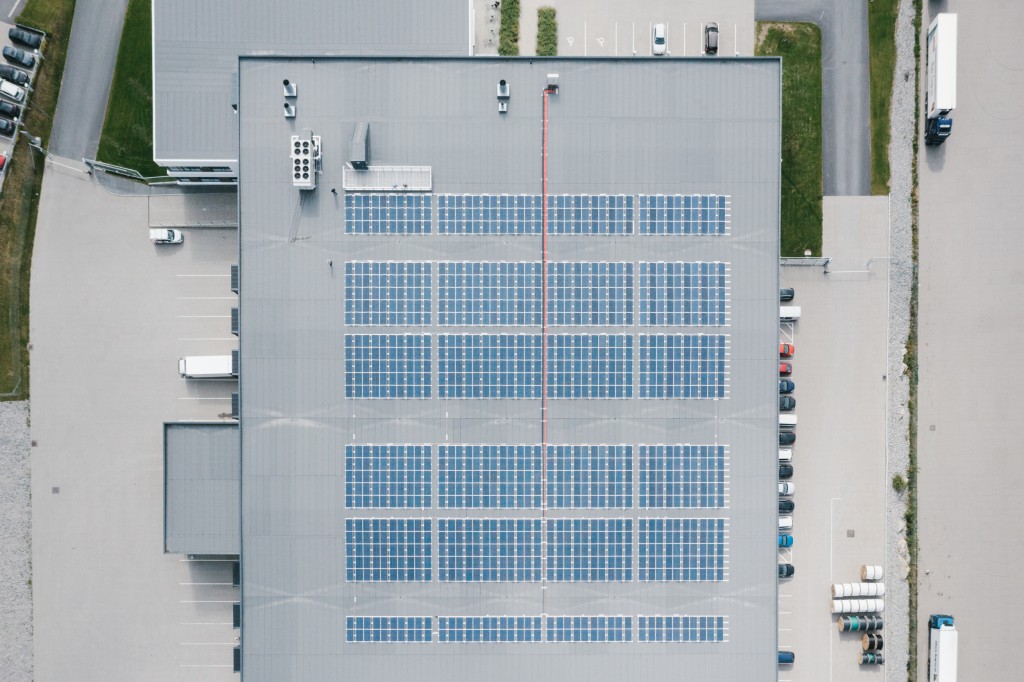 Birds eye view of warehouse with solar panels on roof