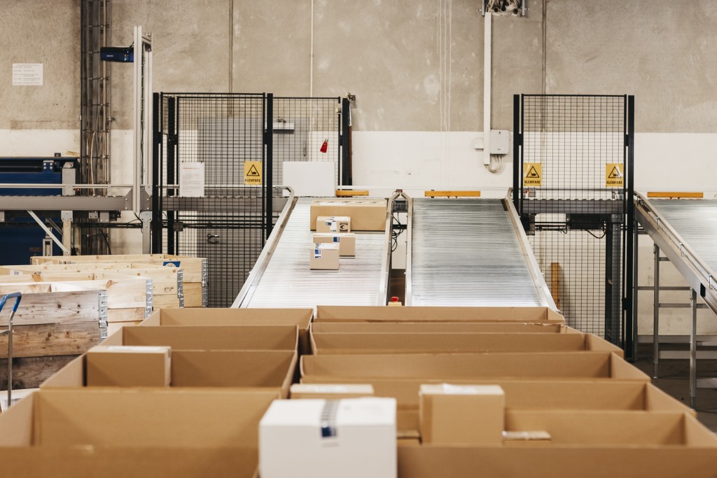 Parcels being transported on conveyor belts in an automated warehouse.
