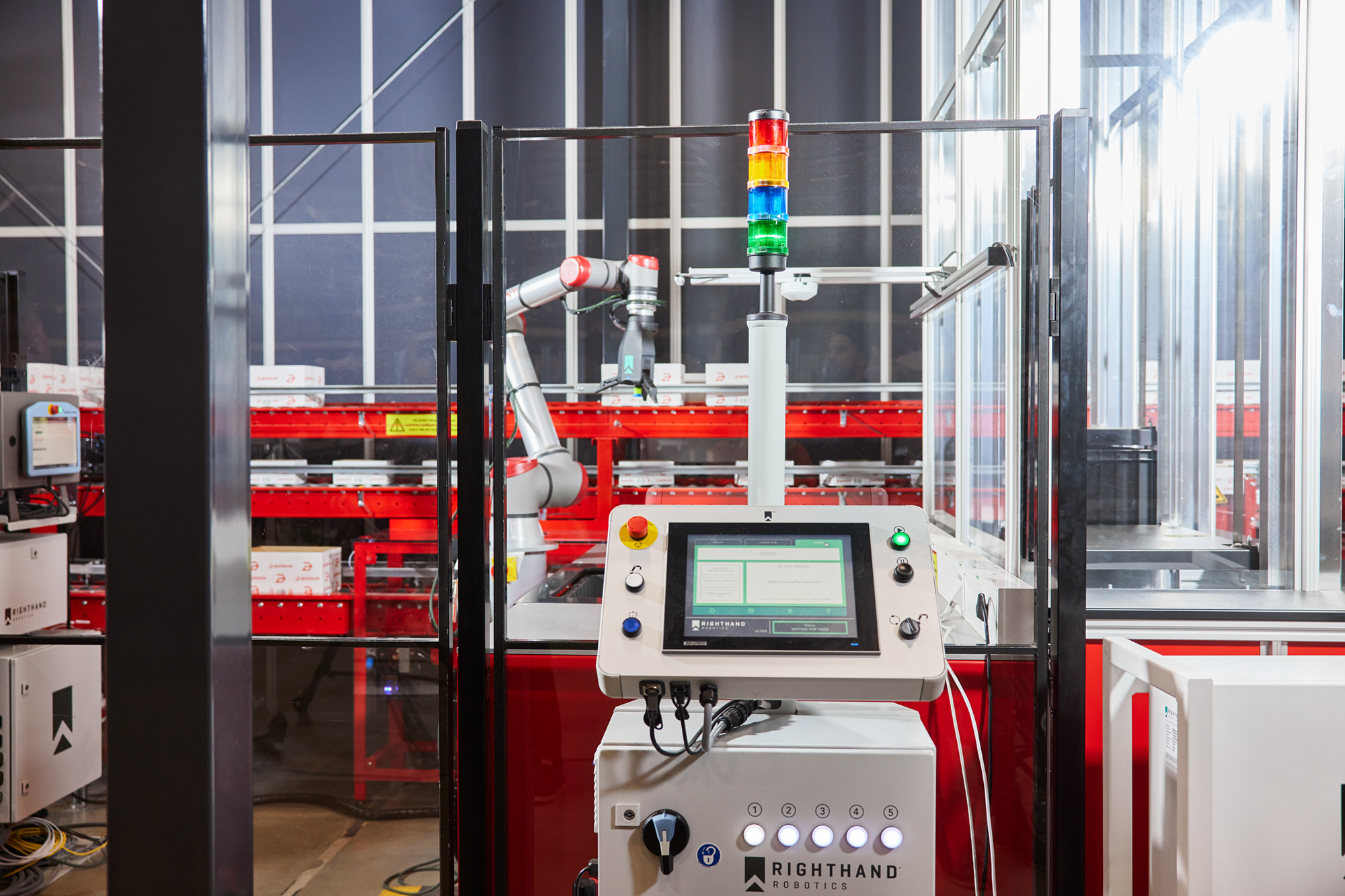 A robotic arm picks orders from AutoStore using piece-picking technology.