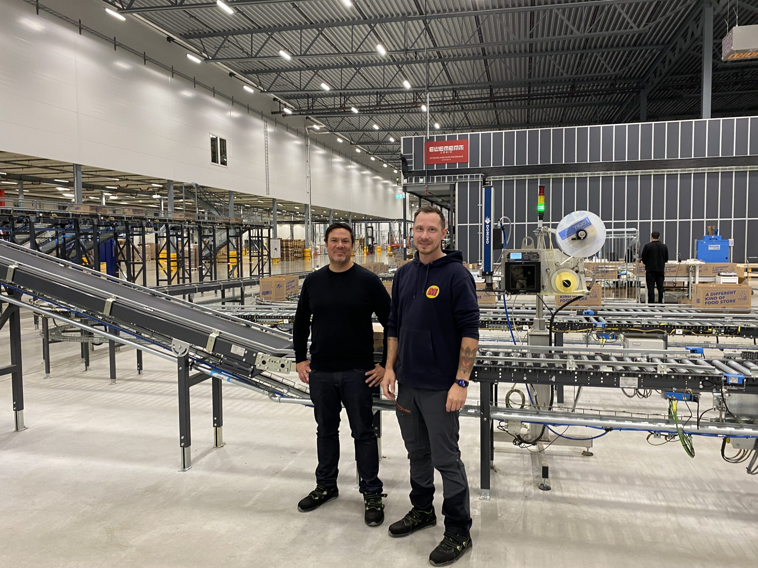 Two Matsmart employees standing in the new automated warehouse